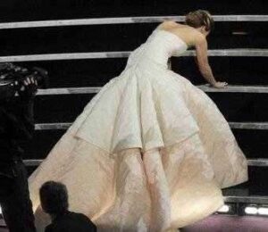 Jennifer Lawrence stumbles as she goes to accept her Oscar